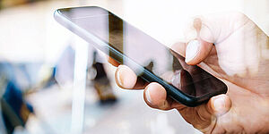 Hand with mobile phone