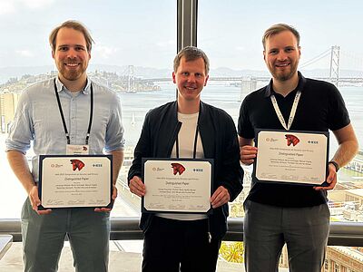  Johannes Willbold, Steffen Becker and Moritz Schlögel celebrate their Distinguished Paper Awards. 